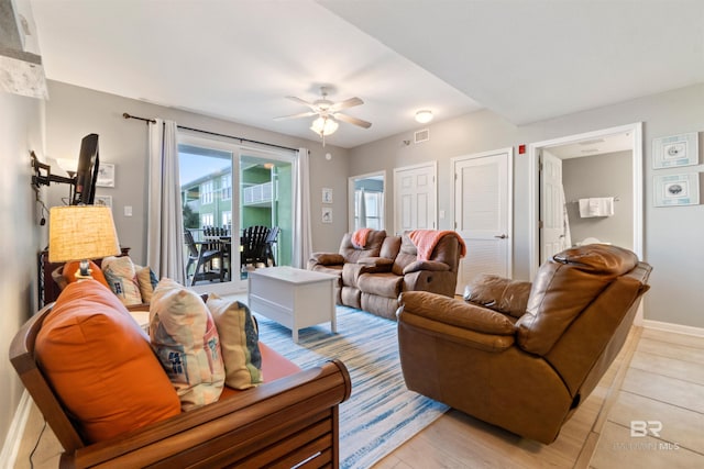 living room with light hardwood / wood-style floors and ceiling fan