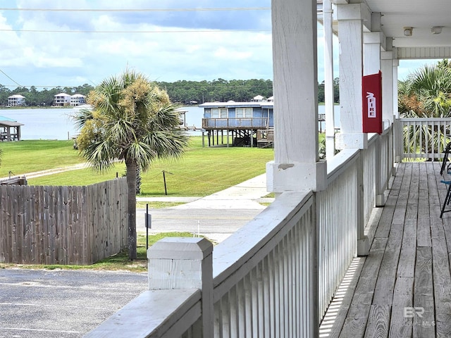 deck featuring a yard and a water view