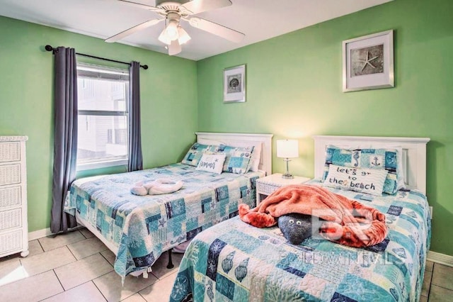 bedroom with ceiling fan and light tile patterned flooring