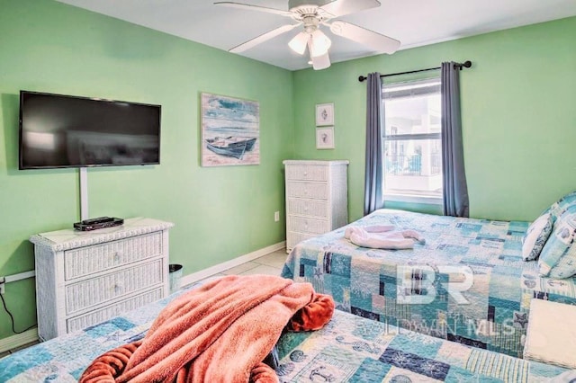 tiled bedroom featuring ceiling fan