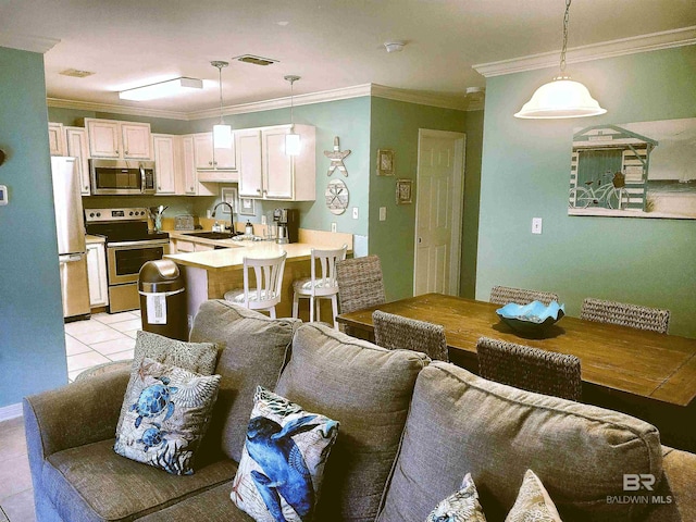 living room with ornamental molding, sink, and light tile patterned floors