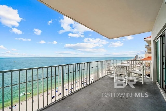 balcony featuring a water view and a view of the beach