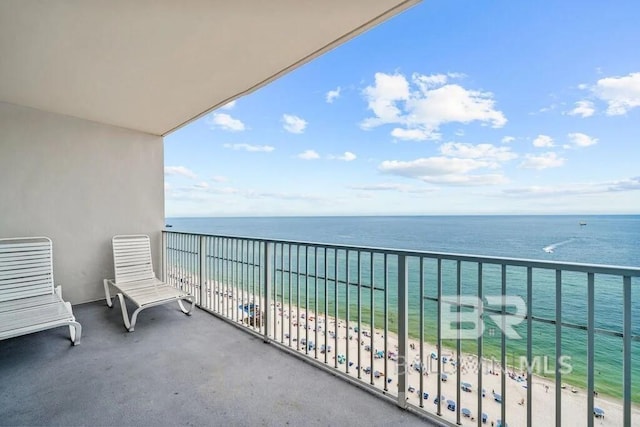 balcony featuring a water view and a view of the beach