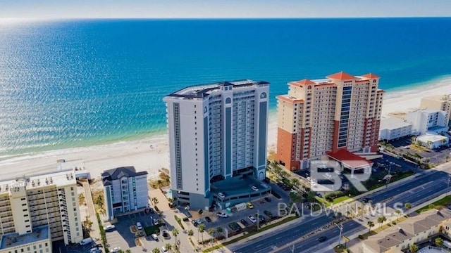 aerial view featuring a water view, a view of city, and a beach view