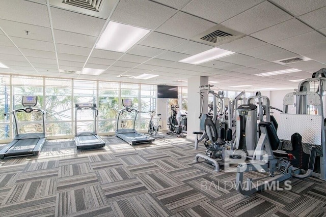 gym featuring expansive windows, carpet floors, and visible vents