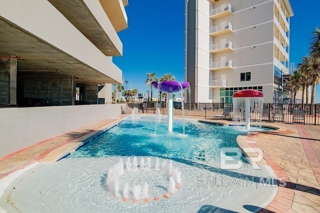 view of pool featuring fence