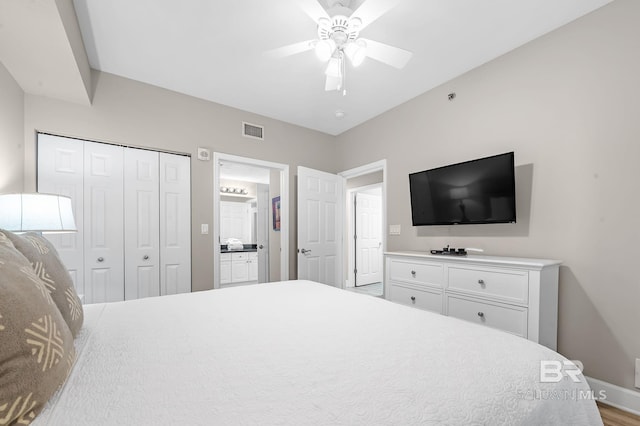 bedroom featuring baseboards, visible vents, a ceiling fan, ensuite bath, and a closet