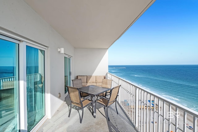 balcony featuring a beach view and a water view