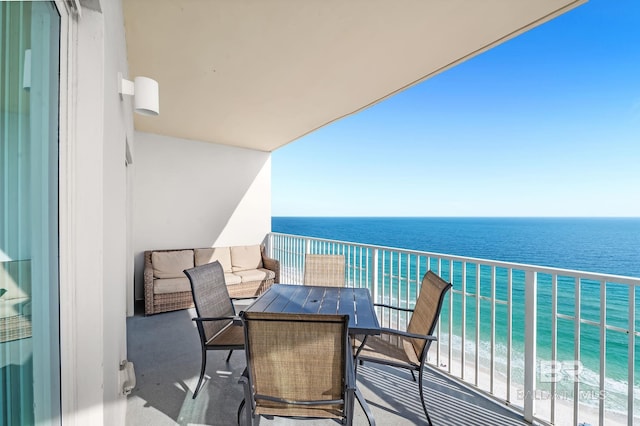 balcony with a water view and a beach view