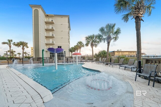 pool with fence and a patio