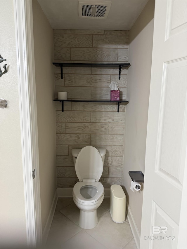 bathroom featuring baseboards, tile patterned flooring, toilet, and visible vents