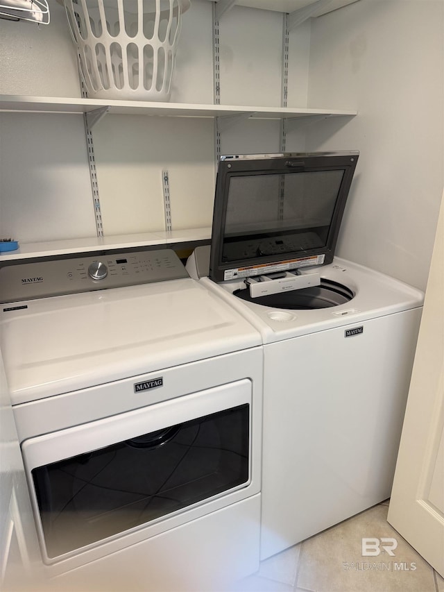 washroom with laundry area, light tile patterned floors, and washing machine and clothes dryer