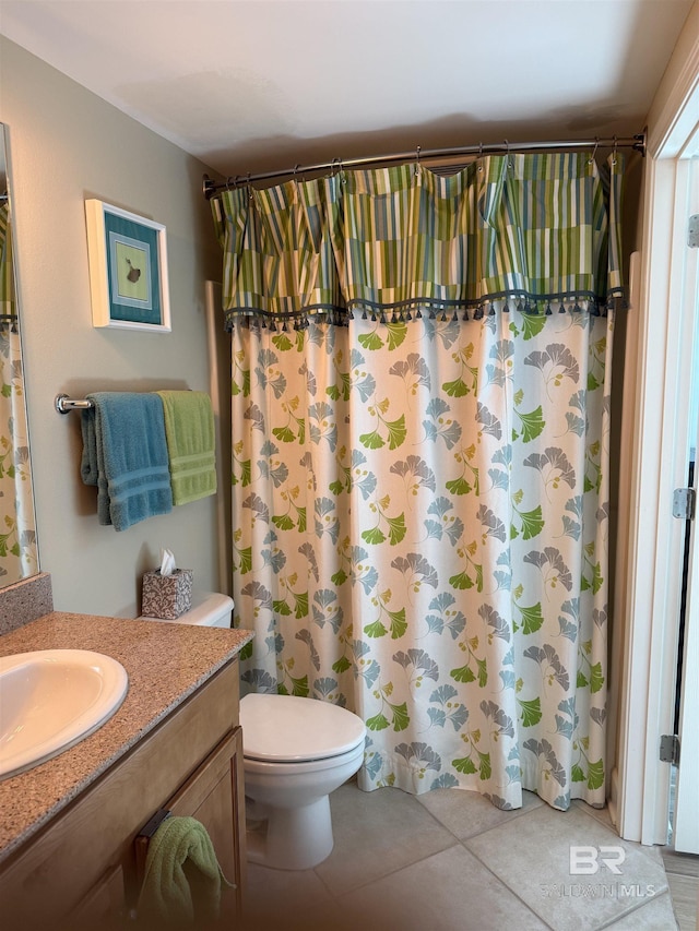 bathroom featuring toilet, tile patterned floors, and vanity