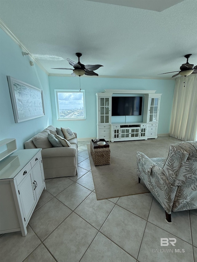 living area with a ceiling fan, a textured ceiling, and light tile patterned flooring