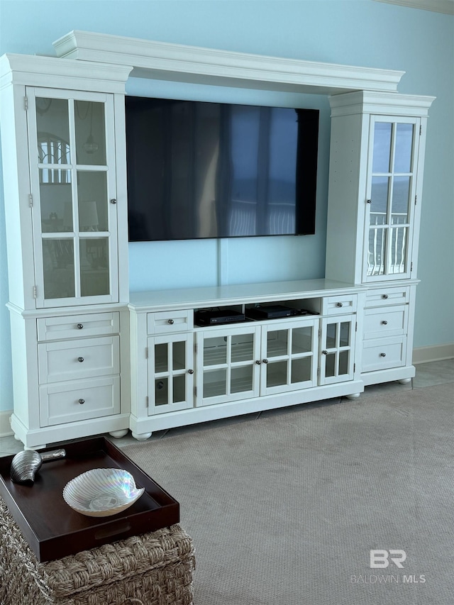 unfurnished living room featuring baseboards and carpet flooring