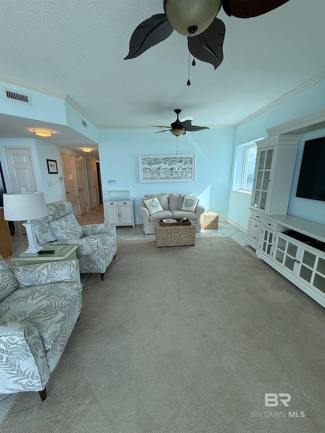 living room with crown molding, carpet, ceiling fan, and visible vents