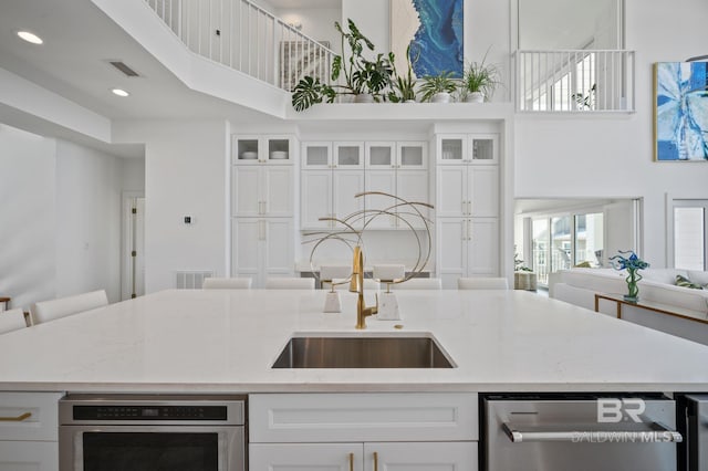 kitchen featuring visible vents and white cabinets