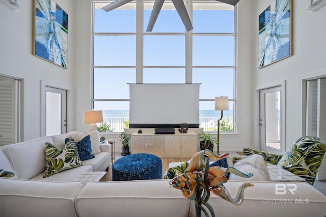 living room featuring a healthy amount of sunlight and a high ceiling