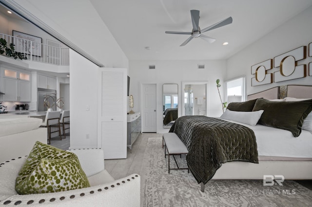 bedroom with a high ceiling, recessed lighting, visible vents, and stainless steel built in fridge