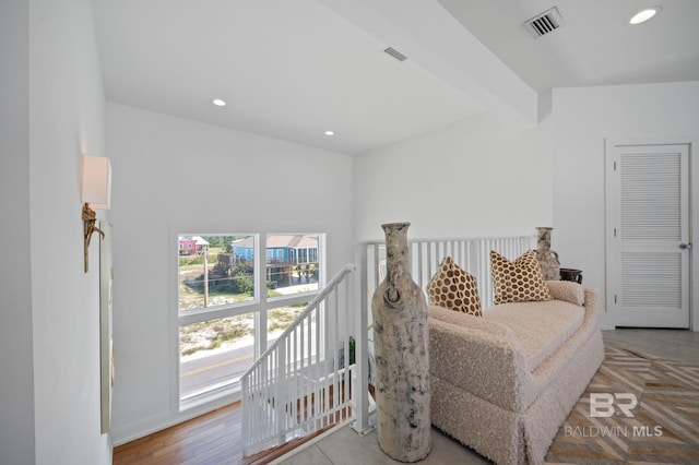 sitting room featuring lofted ceiling with beams, light wood finished floors, visible vents, and recessed lighting