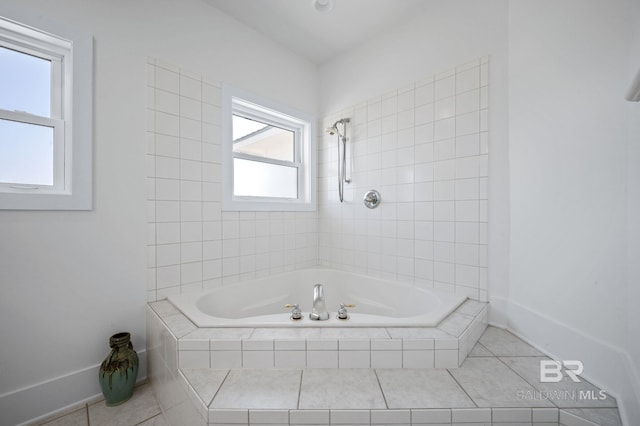 bathroom with tiled tub, baseboards, a tile shower, and tile patterned floors