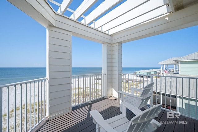 balcony with a water view and a beach view