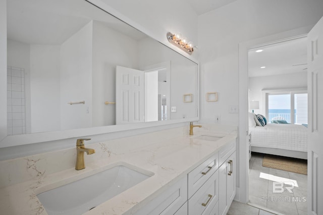 ensuite bathroom with double vanity, recessed lighting, a sink, and ensuite bathroom