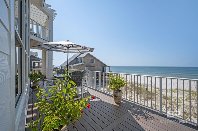 deck featuring a water view and a view of the beach