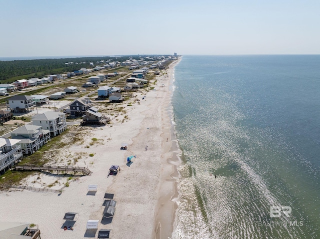 birds eye view of property featuring a beach view and a water view