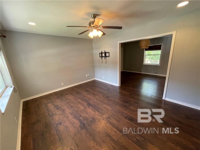 unfurnished room with dark hardwood / wood-style flooring and ceiling fan