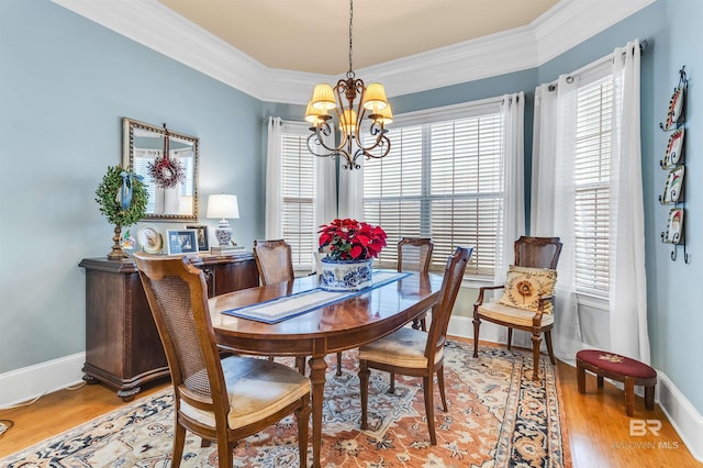 dining space with an inviting chandelier, a wealth of natural light, and baseboards