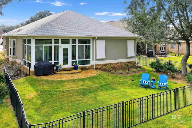 back of house with a sunroom, a lawn, a shingled roof, and stucco siding