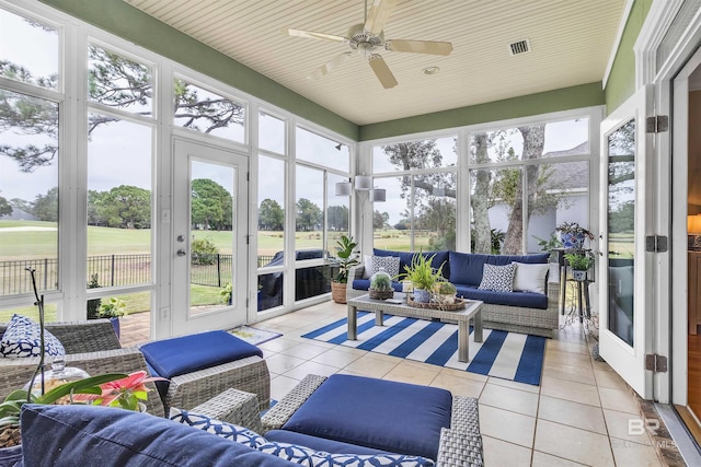 sunroom / solarium featuring visible vents, a ceiling fan, french doors, and an outdoor living space