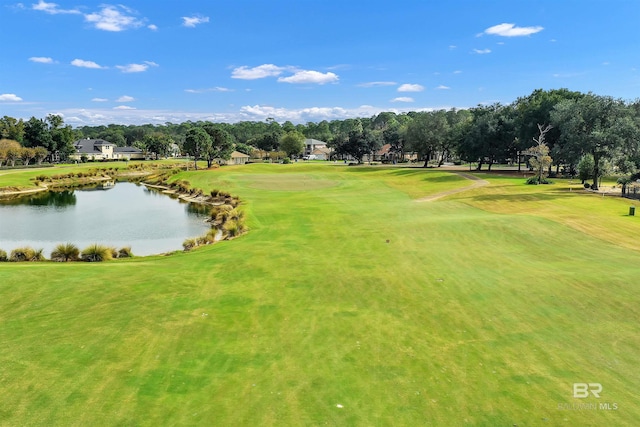 view of home's community with golf course view, a water view, and a lawn