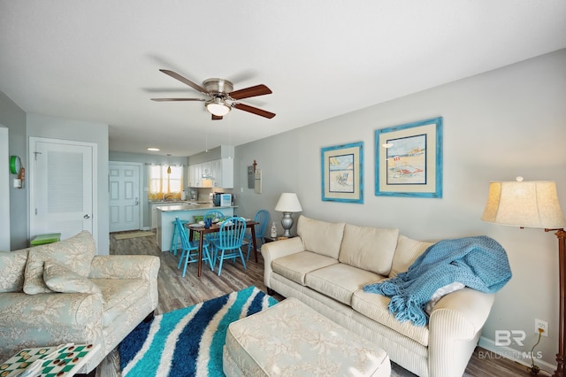 living room with dark wood-type flooring and ceiling fan