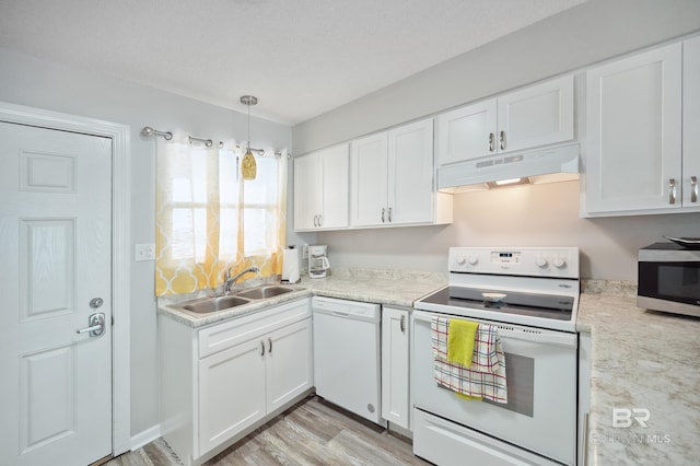 kitchen featuring pendant lighting, sink, white appliances, white cabinetry, and light wood-type flooring