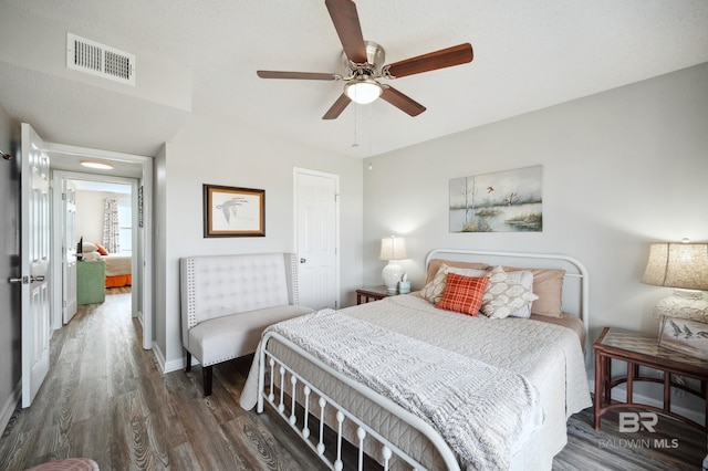 bedroom featuring dark wood-type flooring and ceiling fan