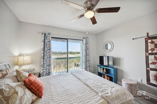 bedroom with ceiling fan, wood-type flooring, access to outside, and a textured ceiling