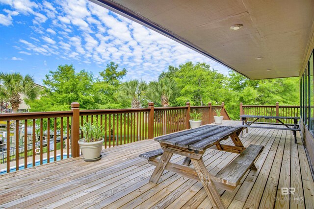 wooden terrace with outdoor dining area