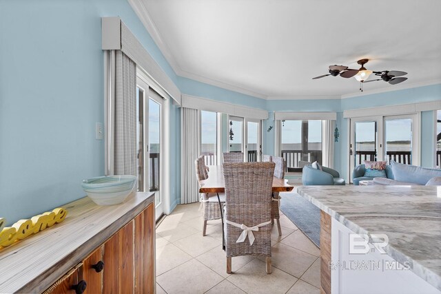 sunroom / solarium with healthy amount of natural light, tile patterned floors, and crown molding