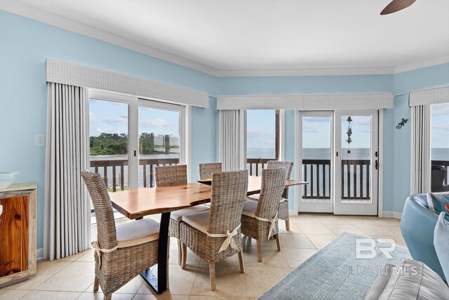dining area featuring light tile patterned floors, ceiling fan, and crown molding