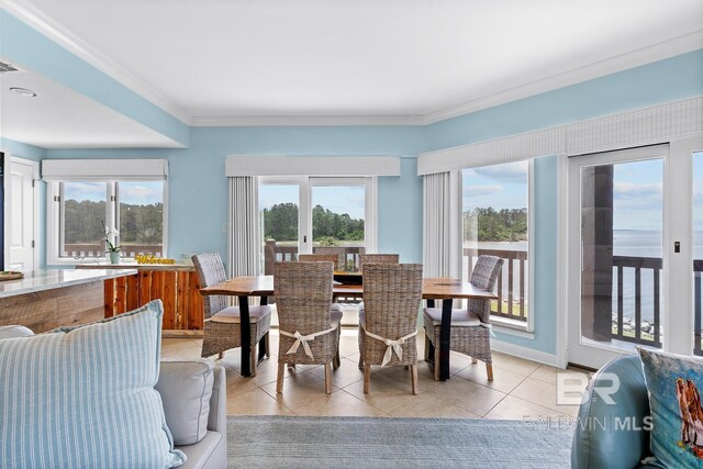 dining space featuring light tile patterned flooring and ornamental molding