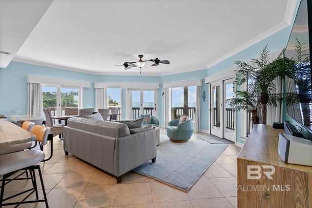 living area featuring ornamental molding, ceiling fan, and light tile patterned floors