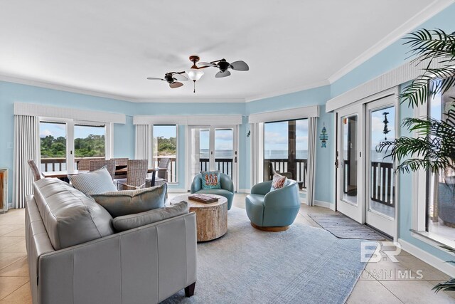 living area featuring light tile patterned flooring, crown molding, a ceiling fan, and french doors
