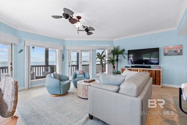 living room with ceiling fan, crown molding, light tile patterned floors, and baseboards