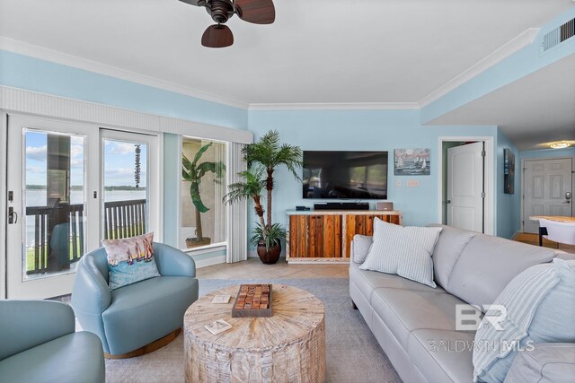 living room with ceiling fan and ornamental molding