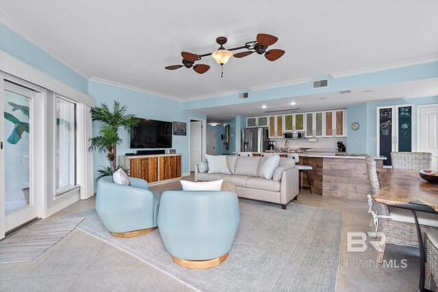 living area featuring crown molding, a ceiling fan, and light tile patterned floors