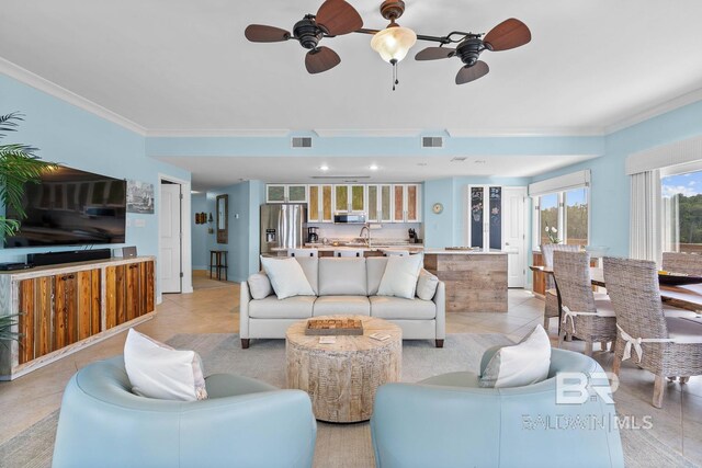 living room featuring ceiling fan, crown molding, and light tile patterned floors