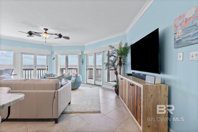 living room with ornamental molding, healthy amount of natural light, a ceiling fan, and light tile patterned floors
