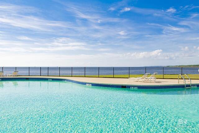 community pool with fence and a patio